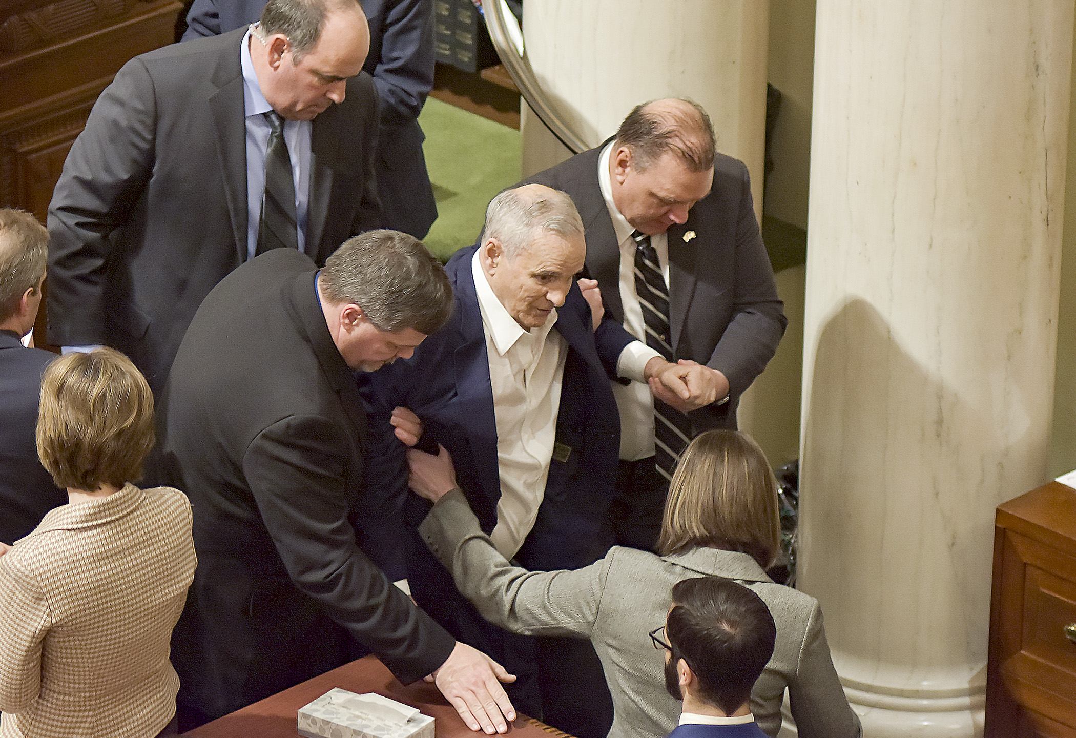 Gov. Mark Dayton is assisted out of the House Chamber after collapsing while delivering his State of the State address Jan. 23. Photo by Andrew VonBank